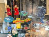 a glass display case with various items in it