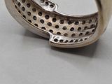 a close up of a silver ring with holes in it