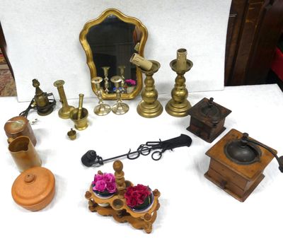 a table with a mirror, a candle holder, a mirror, and other items on it