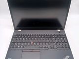 the laptop is open on a white surface with a black keyboard