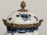 a close up of a blue and white vase with a lid