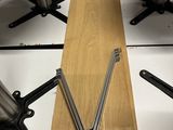 a wooden table with metal legs and a piece of wood in the middle of it