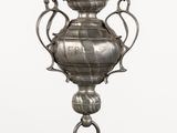 an image of a silver vase hanging from a chain on a white background