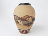 a small vase with a picture of a house on it