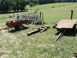 a red trailer and a red wagon in a field