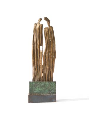 sculpture of a couple embracing each other on a green base