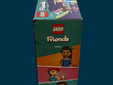 a box of lego friends figures sitting on a table