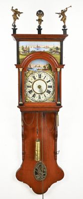 a clock that is hanging on the wall with angels on it