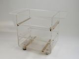 a clear plastic cart with three shelves on it