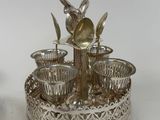 a silver plate with a spoon and cups on it