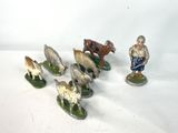 five figurines of a man with a goat and sheep
