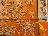 an orange table cloth with a picture of snowflakes on it