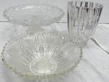 a glass bowl and a glass candle holder on a table