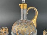 an image of a glass decanter and two glasses on a table