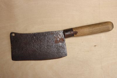 a large knife with a wooden handle on a table