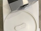 a white container with a black lid on top of a counter
