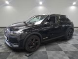 a black suv is parked on a checkered floor in a garage