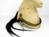 an old helmet with a long black hair on a white background