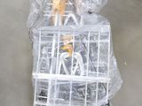 a bird in a cage that is wrapped in plastic