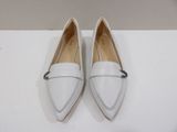 a pair of white shoes on a white surface