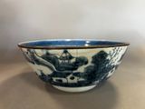 a blue and white bowl sitting on a table