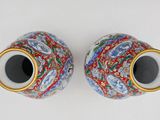 pair of chinese cloise vases with gold rims on a white background