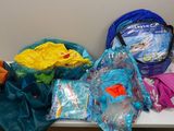 many bags of clothing on a table in the room