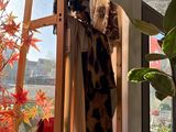a coat rack in the corner of a room next to a window