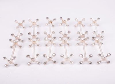 a close up of a bunch of silver balls on a white surface