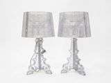 pair of clear glass table lamps with silver shades on a white background