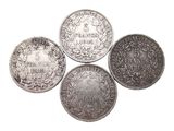 four different types of silver coins on a white background