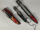 three different types of knives on a white surface