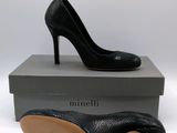 the black high heeled shoe is sitting on top of a box
