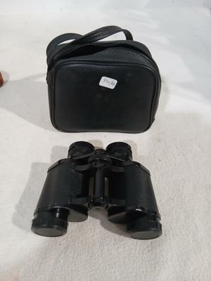 an image of a pair of binoculars sitting on top of a bed