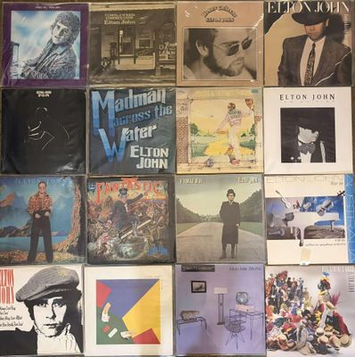 a lot of records on the wall of a room