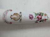 a tube of toothpaste with a shell and flowers on it