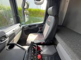 a seat in the driver ' s seat of a bus