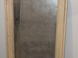 a mirror that is sitting on the floor in a room