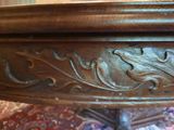 a close up of a wooden table with a floral design on it