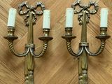 pair of antique brass wall sconces with white candles