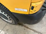 a close up of a yellow truck parked on the side of the road