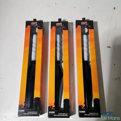 three black and white toothbrushes in a package on a table