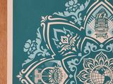 a picture of a teal and white card with a design of a flower