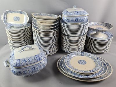 a lot of blue and white plates and bowls on the table