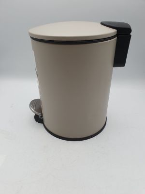 a white and black trash can sitting on top of a white table
