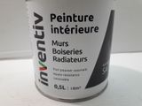 a can of paint sitting on a white table