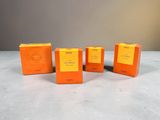 four boxes of orange soap sitting on top of a table