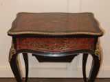 an image of a small table with a red and black top