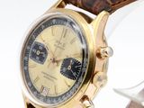 an image of a watch with a gold case and brown leather strap