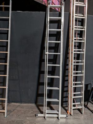 three ladders that are standing next to each other